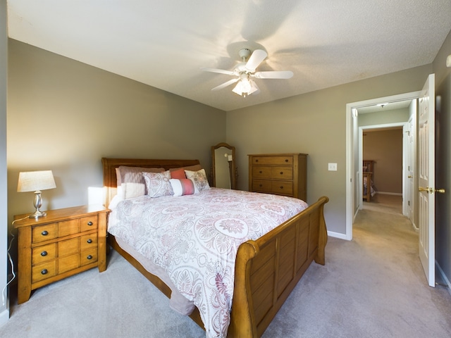 carpeted bedroom featuring a textured ceiling and ceiling fan