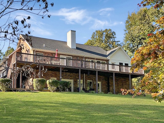 rear view of property with a yard and a deck