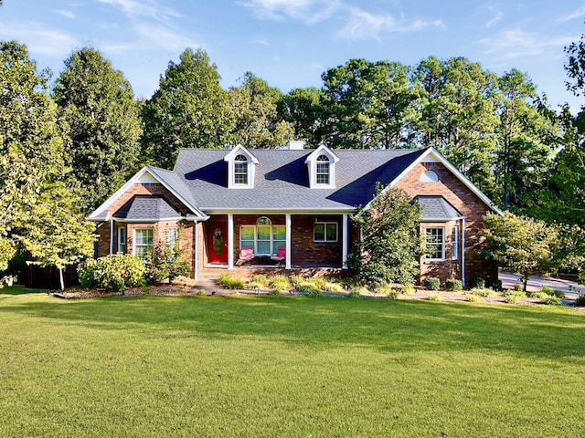 new england style home featuring a front lawn