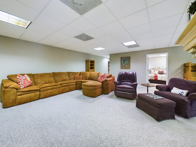 carpeted living room featuring a drop ceiling