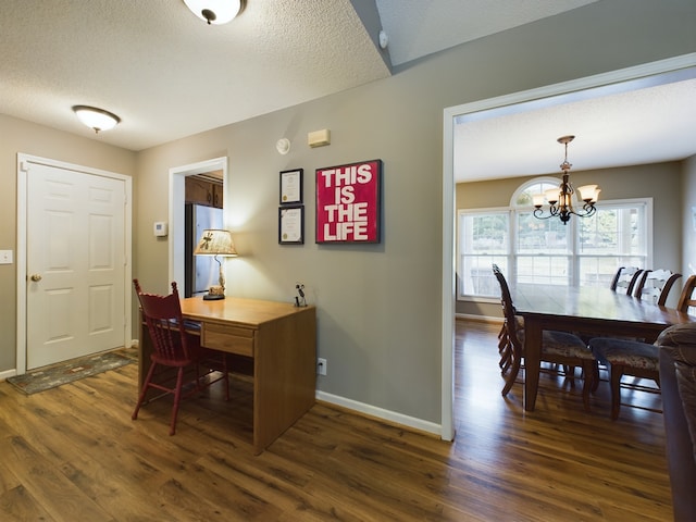 office featuring dark hardwood / wood-style flooring, a textured ceiling, and an inviting chandelier