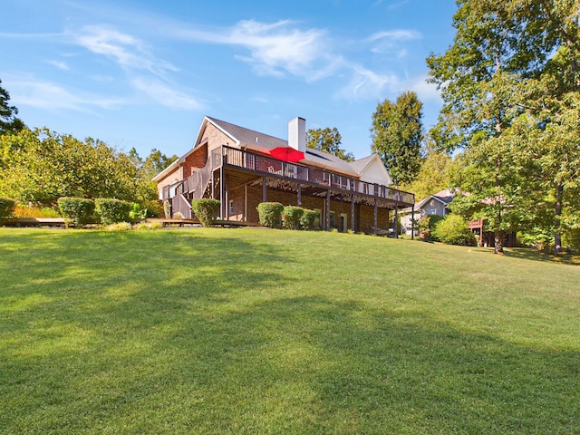 rear view of property with a deck and a lawn