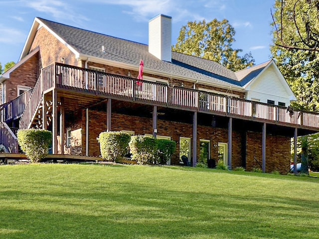 rear view of property featuring a wooden deck and a yard