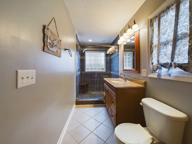 bathroom featuring a textured ceiling, tile patterned flooring, vanity, toilet, and a shower with door