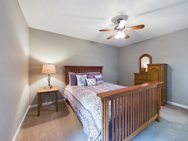 bedroom featuring ceiling fan, a textured ceiling, and carpet flooring