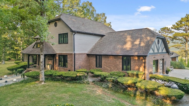 view of front of home with a front lawn and a garage