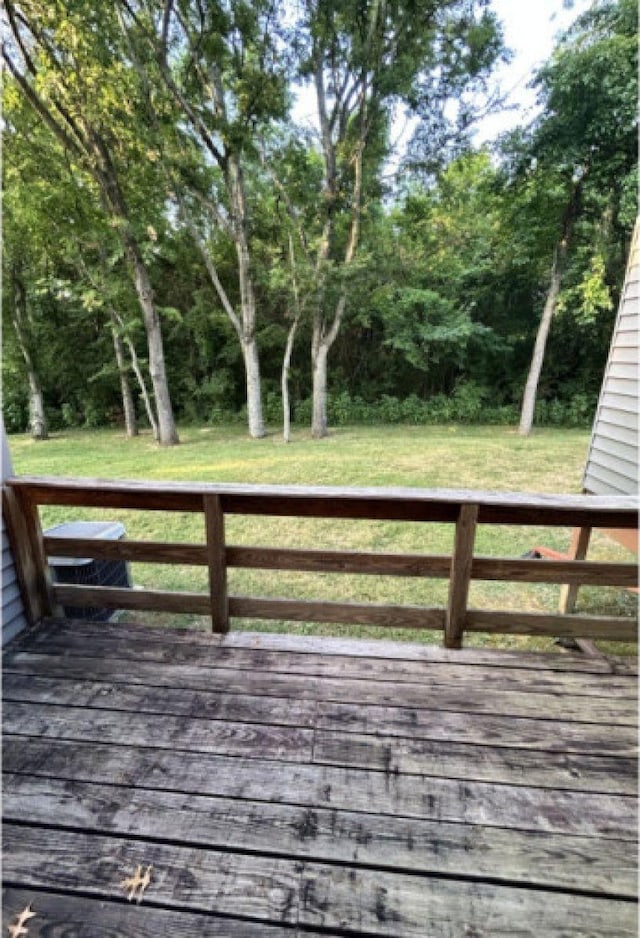 wooden terrace featuring a yard