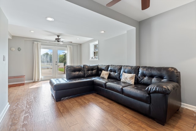 living room featuring ceiling fan, french doors, and wood-type flooring