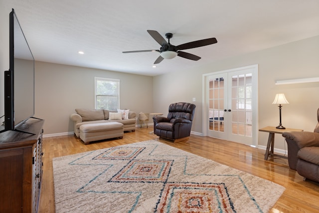 living room with ceiling fan, light wood-type flooring, and french doors