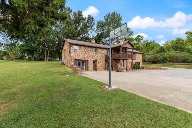 view of side of property with a lawn