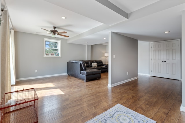 living room featuring ceiling fan and hardwood / wood-style floors