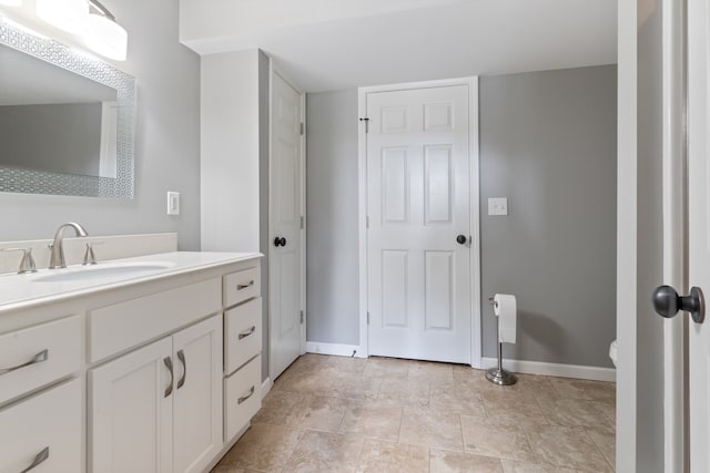 bathroom featuring toilet, tile patterned flooring, and vanity