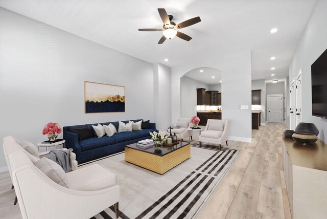 living room with ceiling fan and light hardwood / wood-style floors