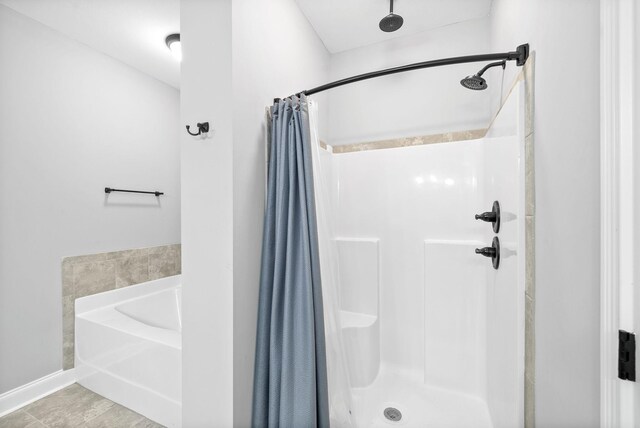 bathroom featuring separate shower and tub