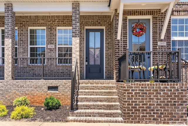 doorway to property with brick siding and crawl space