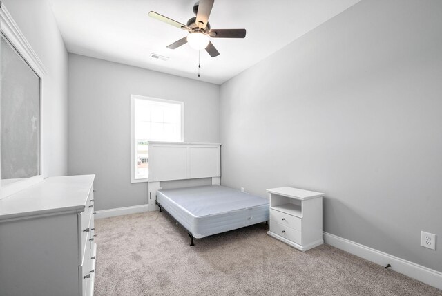 bedroom with ceiling fan and light carpet