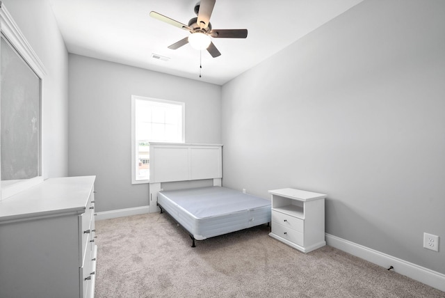 carpeted bedroom with a ceiling fan, visible vents, and baseboards