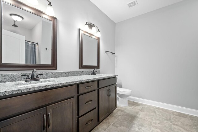 bathroom featuring tile patterned flooring, a shower with shower curtain, vanity, and toilet