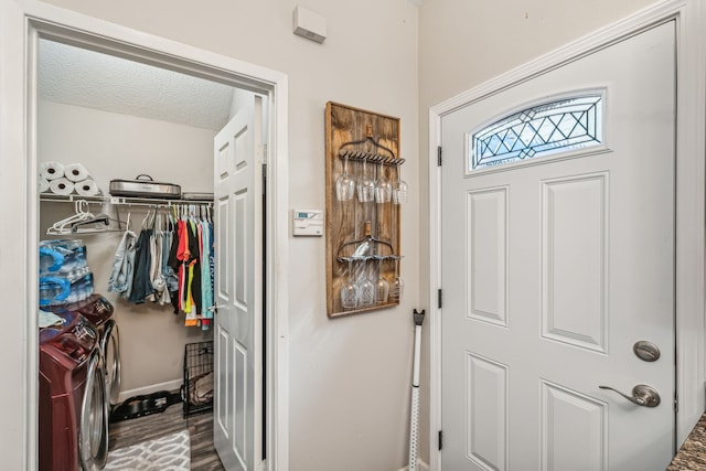 walk in closet with washer and clothes dryer and hardwood / wood-style floors