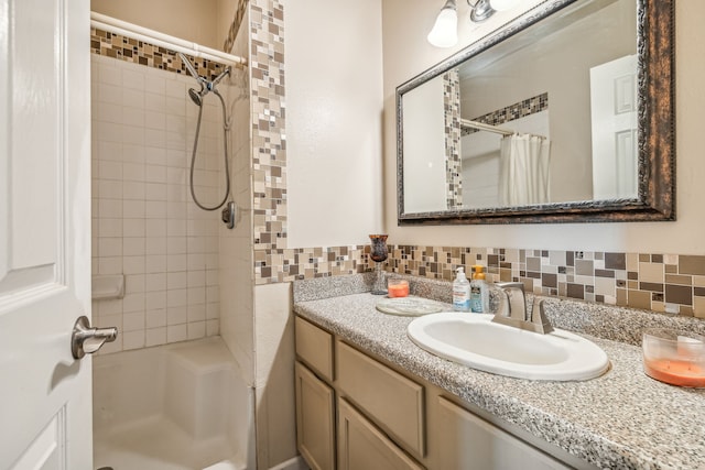 bathroom featuring vanity, backsplash, and a shower with shower curtain