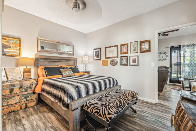 bedroom featuring ceiling fan, a textured ceiling, and dark hardwood / wood-style flooring