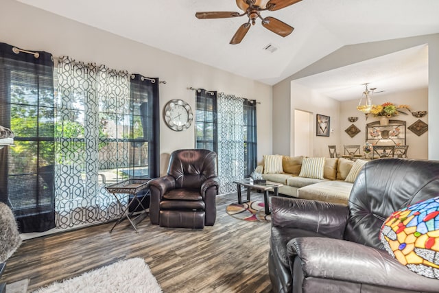 living room featuring ceiling fan, plenty of natural light, lofted ceiling, and dark hardwood / wood-style flooring