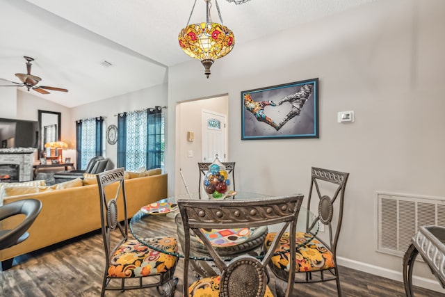 dining room with ceiling fan, dark hardwood / wood-style flooring, and lofted ceiling