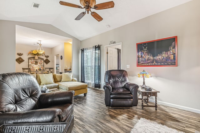 living room featuring dark hardwood / wood-style flooring, lofted ceiling, and ceiling fan