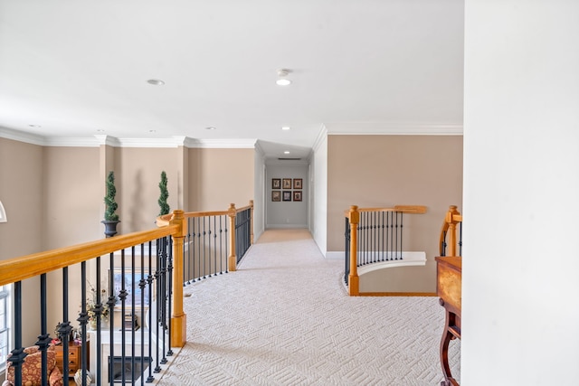 hall with light colored carpet and crown molding