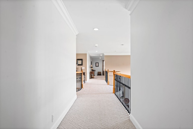 corridor featuring ornamental molding and light carpet