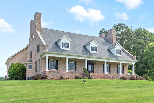 new england style home with central AC unit, a front lawn, and covered porch