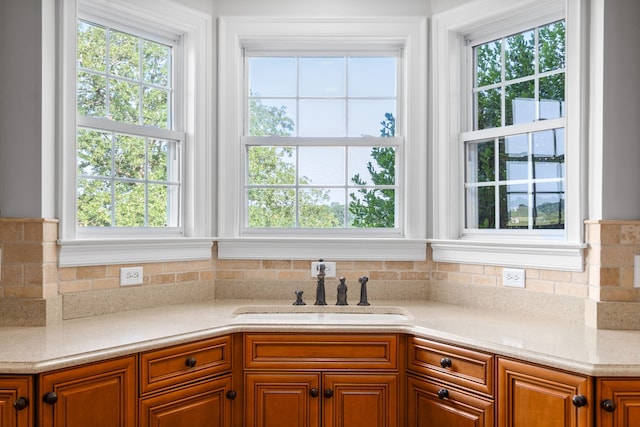 kitchen featuring sink, decorative backsplash, and a wealth of natural light