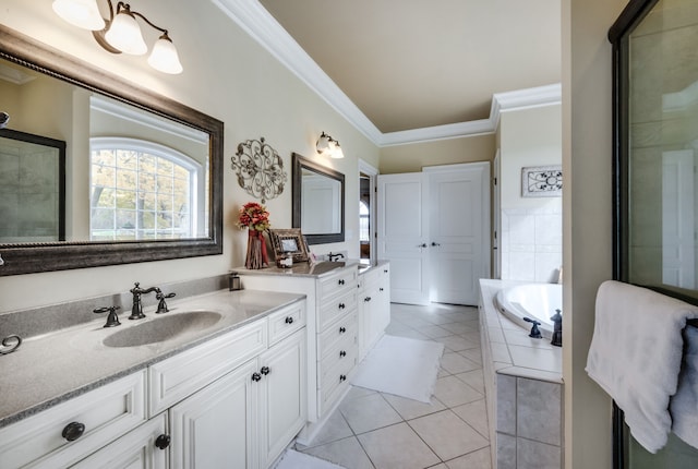 bathroom with tile patterned floors, crown molding, tiled tub, and vanity