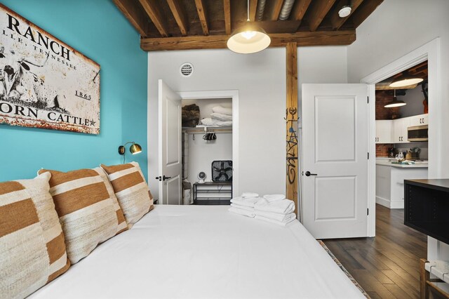 610 21st Ave N Unit 101, Nashville, TN 37203 - bedroom with a closet and dark wood-style floors