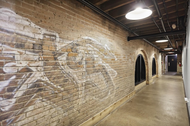 610 21st Ave N Unit 101, Nashville, TN 37203 - hall featuring finished concrete floors and brick wall