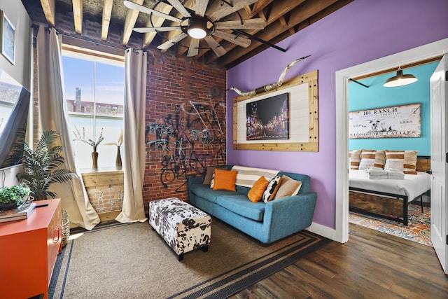 610 21st Ave N Unit 101, Nashville, TN 37203 - living room featuring wood finished floors, brick wall, ceiling fan, and baseboards