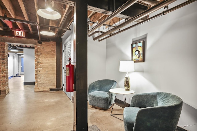 610 21st Ave N Unit 101, Nashville, TN 37203 - living area with brick wall and finished concrete floors