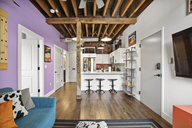 610 21st Ave N Unit 101, Nashville, TN 37203 - living area featuring dark wood-type flooring, beam ceiling, and baseboards