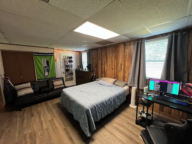 bedroom with hardwood / wood-style flooring and a drop ceiling