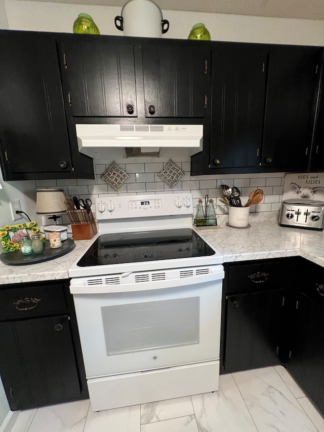 kitchen with white range with electric cooktop, light tile patterned floors, and tasteful backsplash