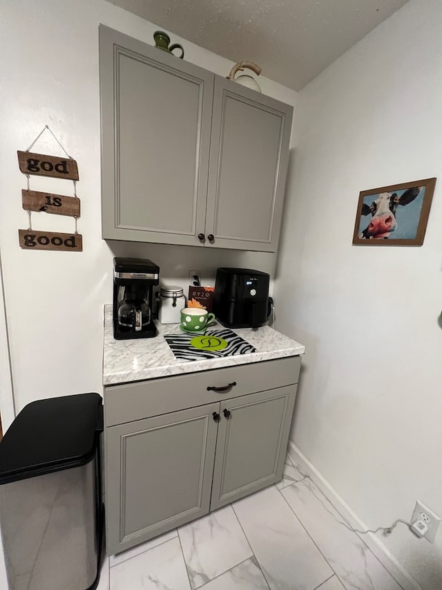 laundry area featuring light tile patterned flooring