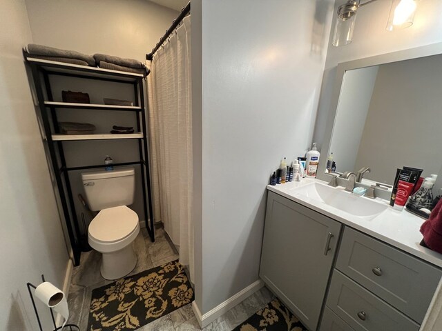 bathroom featuring toilet, vanity, and tile patterned floors