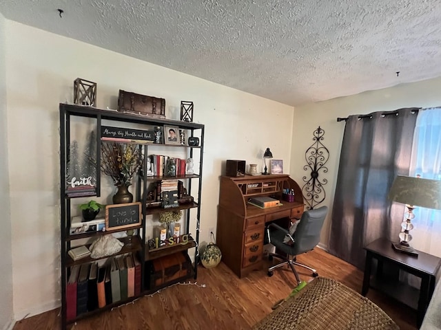 home office featuring wood-type flooring and a textured ceiling