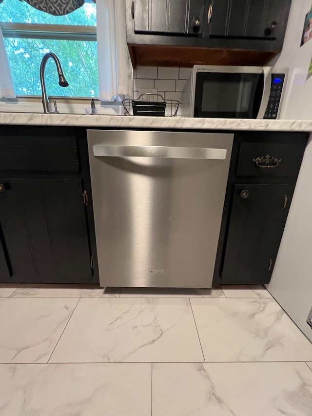 kitchen with stainless steel appliances and decorative backsplash