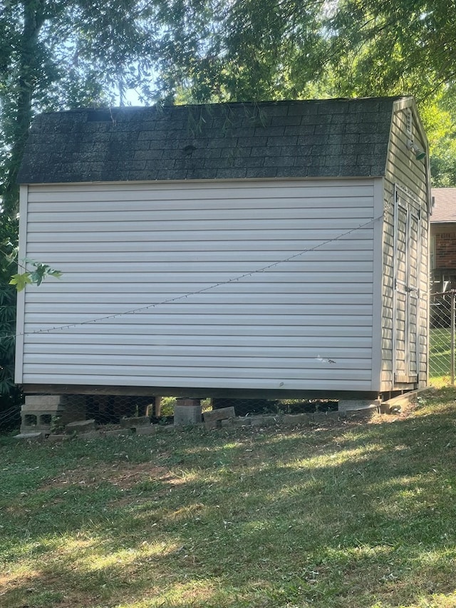 view of property exterior with a yard and a shed