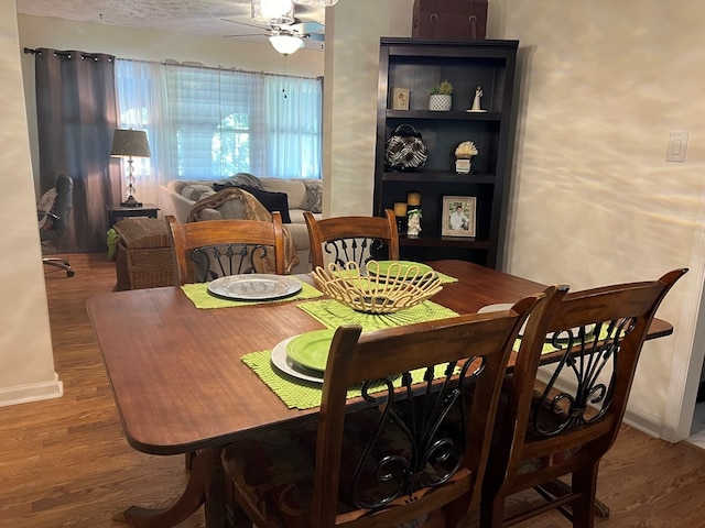 dining area featuring ceiling fan and wood-type flooring