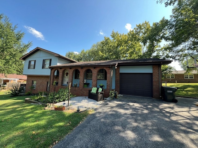 tri-level home with a garage and a front lawn