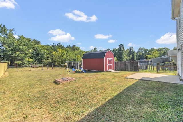 view of yard with a patio, a playground, and a storage unit