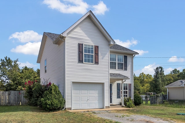 view of property featuring a garage and a front yard