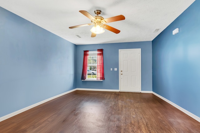 empty room featuring ceiling fan and hardwood / wood-style floors